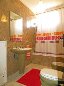 a bathroom with a toilet and a sink and a shower at Casa de Santo Amaro in Vila do Conde