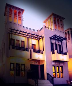 a large white building with steps in front of it at Kaleidoscope in Ajman 
