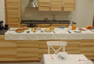 a kitchen with a table with plates of food on it at La stazione in Monselice