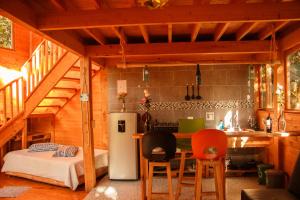 a kitchen with a refrigerator and a table in a room at Hospedaje Solentiname in Medellín