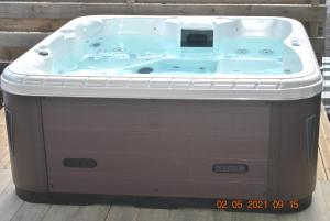 a jacuzzi tub sitting on a wooden floor at Villa Morene in Sainte-Anne