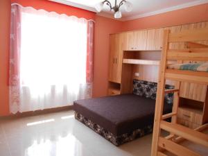 a bedroom with two bunk beds and a window at Family Holiday Home in Hajdúszoboszló