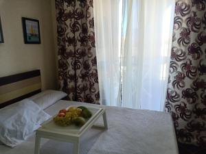 a table with a tray of fruit on a bed at شاليهات بورتو مطروح فيو بحر Porto Matrouh Sea View Families Only in Marsa Matruh