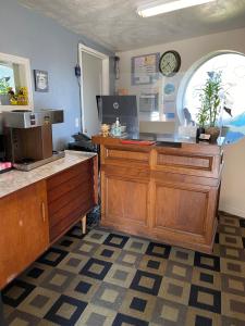 a kitchen with a counter and a clock on the wall at Villa West Motel in Florence