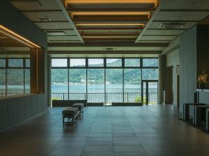 a large room with a view of the water at Grandvrio Hotel Miyajima Wakura - ROUTE INN HOTELS - in Hatsukaichi