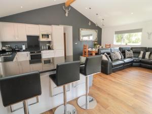 a kitchen and living room with black and white furniture at The Woodside in Newcastle upon Tyne