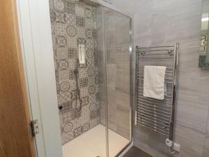 a shower with a glass door in a bathroom at The Woodside in Newcastle upon Tyne +28 photos