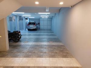 a hallway with a car parked in a garage at Veeras Residency in Puducherry