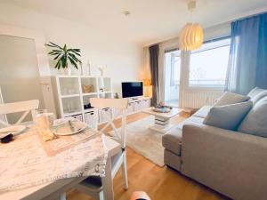a living room with a couch and a table at Ferienwohnung "Sylt Sunrise" in Westerland (Sylt)