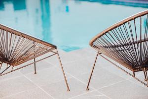 two benches sitting in the middle of a pool at Quest Wodonga in Wodonga
