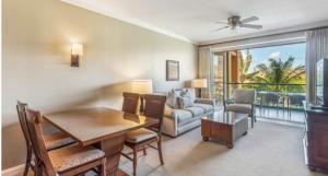 a living room with a dining table and a couch at 1 BR Luxury Condo in Presitigious Honua Kai Resort #k430 in Lahaina