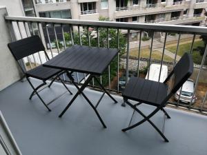 een picknicktafel en 2 stoelen op een balkon bij Ravissant studio proche de la Loire in Orléans