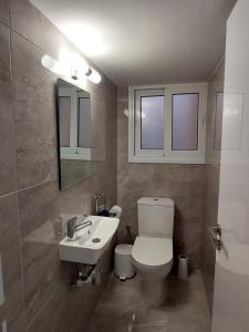 a bathroom with a white toilet and a sink at Hawaii Holiday Apartment 41 in Limassol +20 photos
