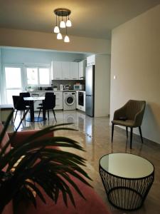 a kitchen and living room with a table and chairs at Hawaii Holiday Apartment 41 in Limassol