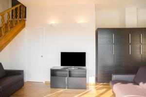 a living room with a tv and a couch at Apartments Florence - Pier Capponi Duomo in Florence