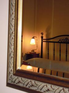
Ένα ή περισσότερα κρεβάτια σε δωμάτιο στο Atheaton Traditional Guest Ηouse Nafplion
