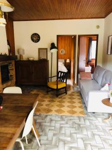 a living room with a couch and a table at Pont de Frappe in Chabottes