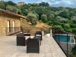 a patio with chairs and a table on a balcony at B&b Il Poggio Eccelso in Ogliastro Cilento