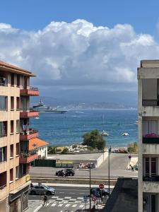 a large cruise ship in the ocean with a city at Joli studio spacieux in Ajaccio