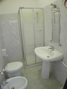 a bathroom with a toilet and a sink and a shower at Hotel Villa Cesare B&B in Alba Adriatica