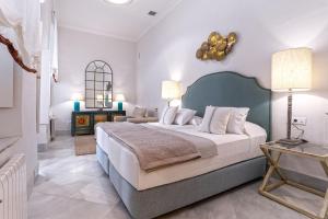 a bedroom with a large bed in a room at Genteel Home Palacio Abades in Seville