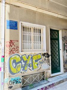 a building with graffiti on the side of it at House in House at the Heart of Exarchia, extremely central in Athens