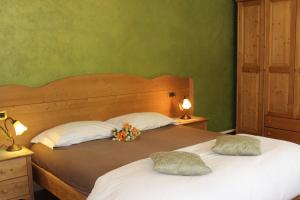 a bedroom with two beds with flowers on them at B&B Villa Cinzia Ledro in Ledro