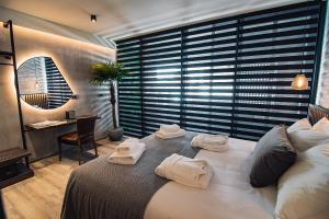 A bed or beds in a room at Project 3 Urban Chic Hotel