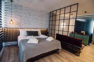 A bed or beds in a room at Project 3 Urban Chic Hotel