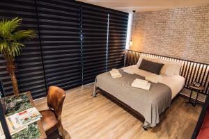A bed or beds in a room at Project 3 Urban Chic Hotel