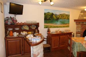 a room with a table with food and a painting on the wall at B&B Villa Cinzia Ledro in Ledro +22 photos
