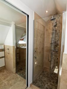 a shower with a glass door in a bathroom at Casa Anca Deluxe in Sarlat-la-Canéda +9 photos