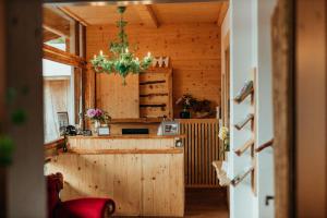 a kitchen with a counter and a chandelier at Hotel Am Fichtelsee in Fichtelberg