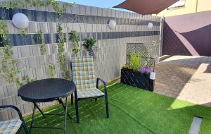 a patio with a table and chairs on the grass at Studio Appartement in Speichersdorf