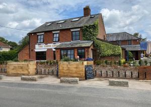 a brick house with a sign in front of it at The Three Lions in Fordingbridge