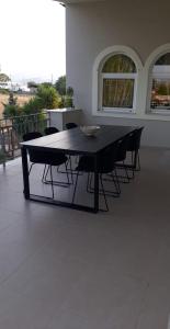 a black table and chairs on a patio at The Villa of the Winds in Néa Kíos