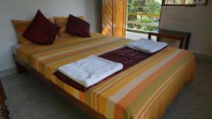 Ein Bett oder Betten in einem Zimmer der Unterkunft Green's Guest House