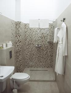 a bathroom with a shower with a toilet and a sink at Residence Odesskij Dvorik in Odesa