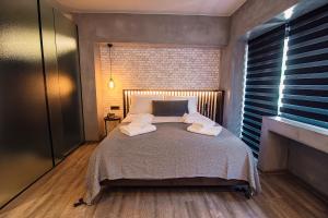 A bed or beds in a room at Project 3 Urban Chic Hotel