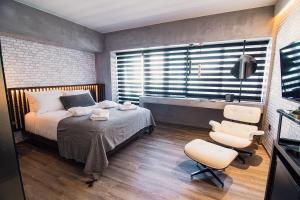 A bed or beds in a room at Project 3 Urban Chic Hotel