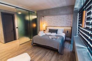 A bed or beds in a room at Project 3 Urban Chic Hotel