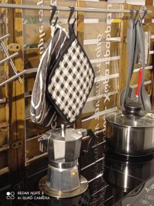 a kitchen utensil rack with a tea pot and towels at A casa di Andrea e Lucia in Gaeta