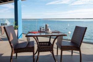 a table and two chairs with a view of the ocean at Apartments Zanic on The Beach in Podstrana