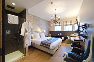 um quarto de hotel com uma cama e um chuveiro em Hotel Saint-Amour em Durbuy