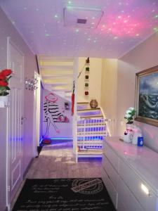 a childs room with a pink ceiling and a crib at Scandinavian Sleeping & Living in Turku