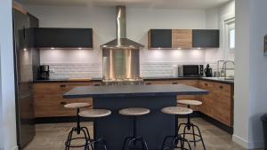 a kitchen with a blue counter and stools at Gîte Les Vernes du Léman 11 à 13 pers in Maxilly-sur-Léman