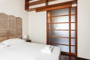 Posteľ alebo postele v izbe v ubytovaní De Angeli Cozy Apartment- Youhosty