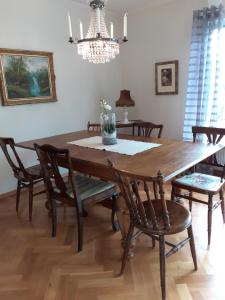 a dining room table with chairs and a chandelier at Villa mitt i Ullared - 400m till Gekås in Ullared +11 photos
