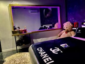 a teddy bear sitting on a bed in a room at #BBSH in Goussainville