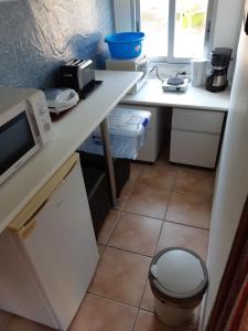 a small kitchen with a counter and a sink at Nice room with swimming pool in Cocentaina